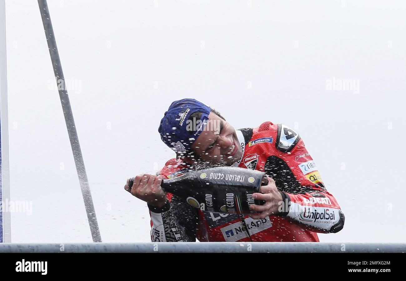 Italian rider Danilo Petrucci of the Ducati Team sprays champagne to celebrate his victory after the MotoGP race of the French Motorcycle Grand Prix at the Le Mans racetrack, in Le Mans, France, Sunday, Oct. 11, 2020. (AP Photo/David Vincent) Banque D'Images