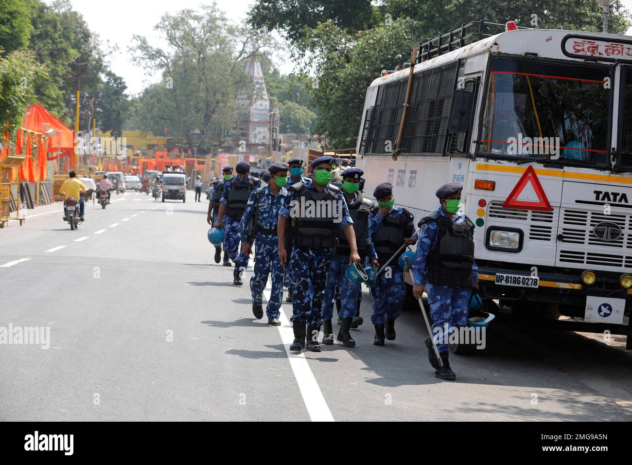 Security personnel patrol a street ahead of a groundbreaking ceremony