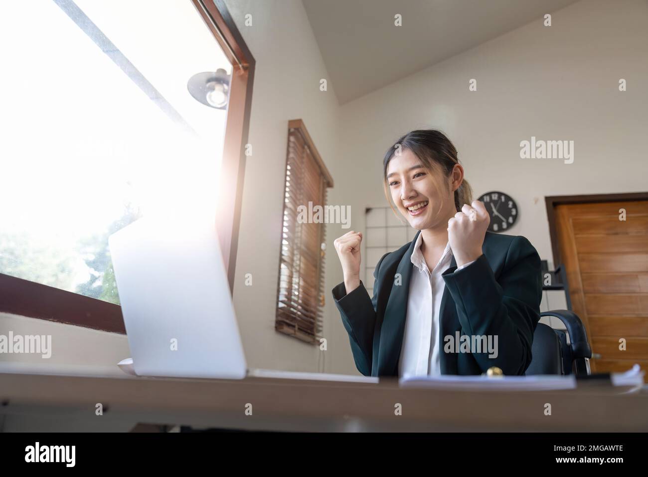 Heureuse femme d'affaires réussie et excitée triomphant au bureau. femme asiatique travaillant sur un ordinateur portable Banque D'Images