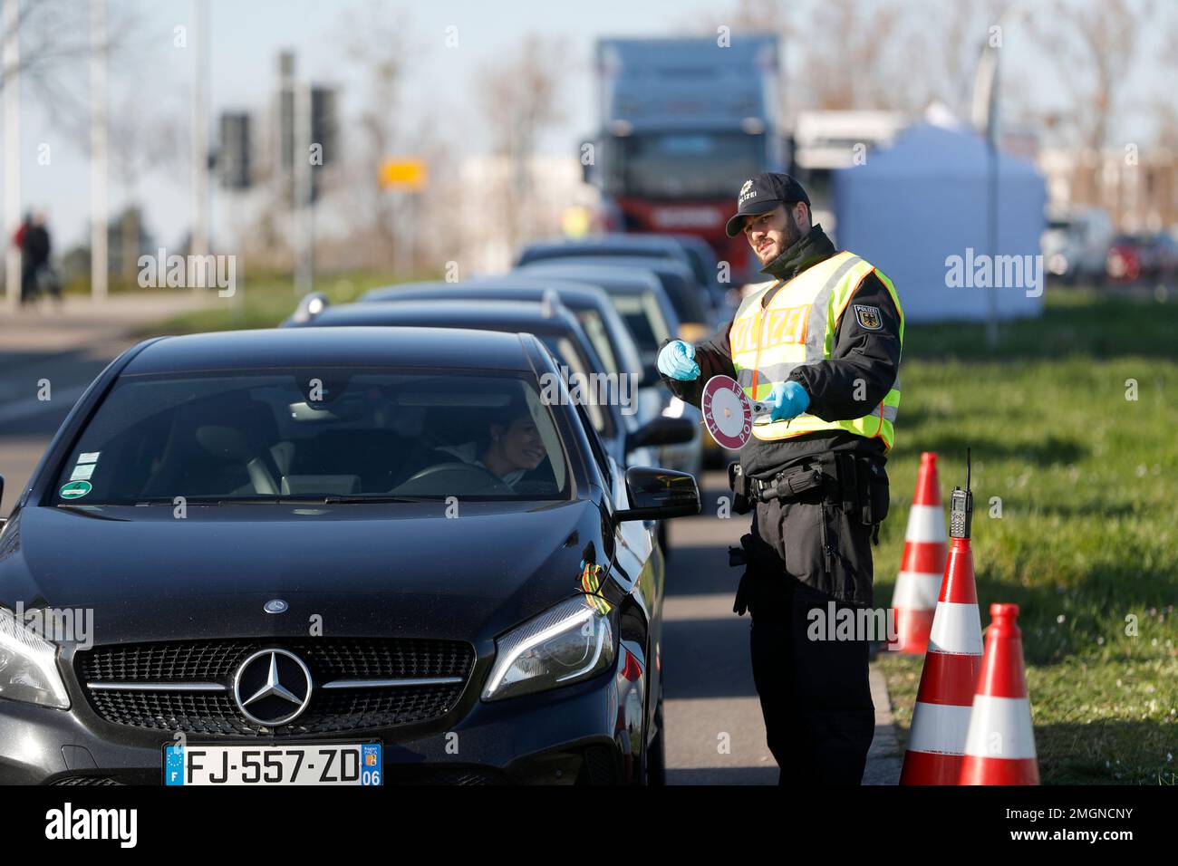 A German police officer checks vehicles at the German-France border in Kehl, Monday March 16, 2020. Germany partially closes its borders with France, Switzerland, Austria, Luxembourg and Denmark as it steps up efforts to stem the spread of the new coronavirus. For most people, the new coronavirus causes only mild or moderate symptoms. For some it can cause more severe illness. (AP Photo/Jean-Francois Badias) Banque D'Images