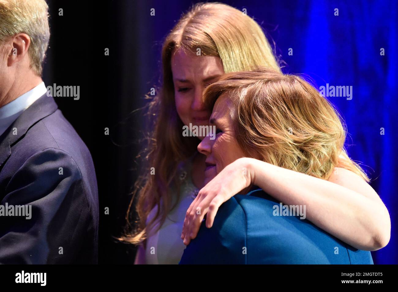 Democratic presidential candidate Tom Steyer's daughter, Evie, center, hugs  her mother, Kat Taylor, as Steyer speaks during his presidential campaign  Saturday, Feb. 29, 2020, in Columbia, S.C. Billionaire activist Steyer took  third