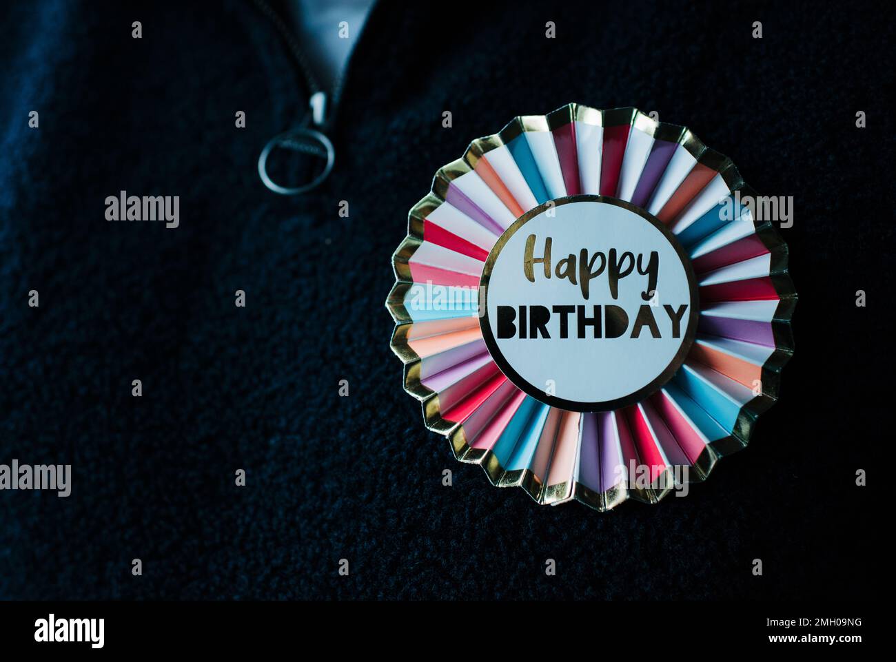 badge joyeux anniversaire coloré sur les vêtements Banque D'Images