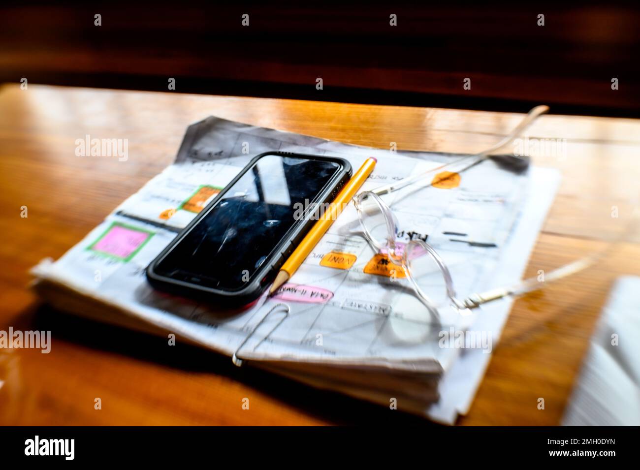 Un téléphone portable et des lunettes en haut des pages d'un calendrier Banque D'Images