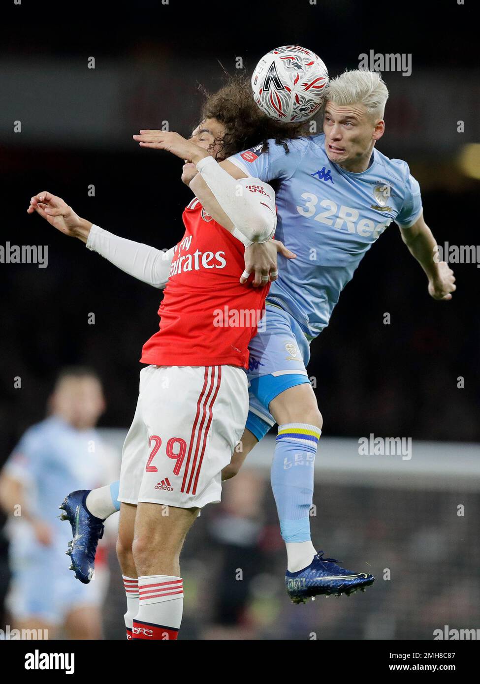 Arsenal's Matteo Guendouzi, left, and Leeds United's Ezgjan Alioski challenge for the ball during the English FA Cup soccer match between Arsenal and Leeds United at the Emirates Stadium in London, Monday, Jan. 6, 2020.(AP Photo/Kirsty Wigglesworth) Banque D'Images