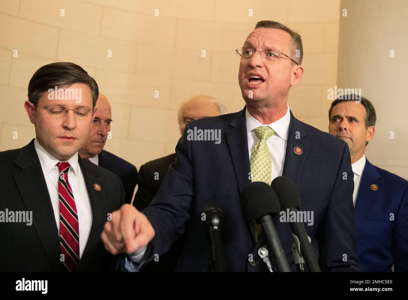 House Judiciary Committee ranking member Rep. Doug Collins, R-Ga., center, accompanied by Rep. Mike Johnson, R-La., and Rep. John Ratcliffe, R-Texas, right, speaks to reporters at the end of a House Judiciary Committee markup of the articles of impeachment against President Donald Trump, on Capitol Hill, Thursday, Dec. 12, 2019, in Washington. (AP Photo/Manuel Balce Ceneta) Banque D'Images