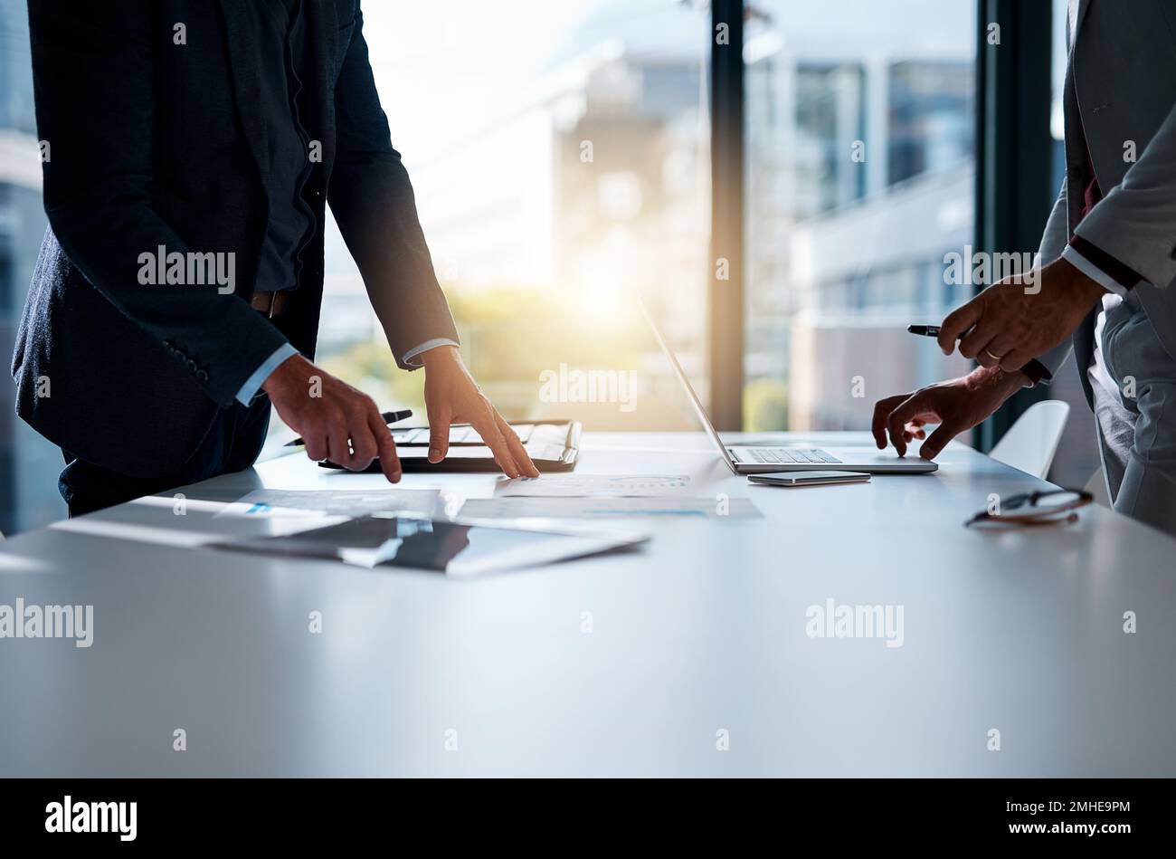 Mettre la paperasserie en perspective. deux hommes d'affaires méconnaissables discutent de paperasserie à la table de la salle de réunion. Banque D'Images