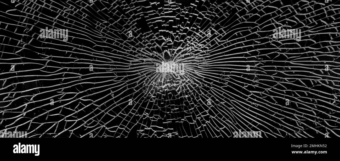 Texture verre cassé avec fissures. Résumé de fenêtre fissurée sur noir. Banque D'Images