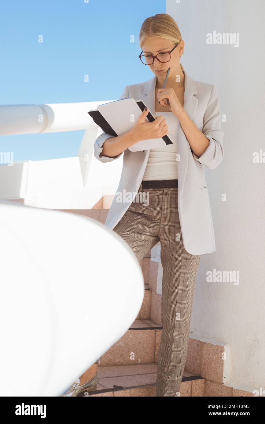 Jeune femme d'affaires blonde pensant à de nouvelles idées de projet. Banque D'Images