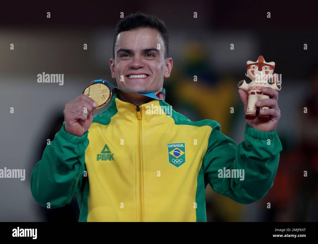 Caio Souza of Brazil celebrates at the podium after winning a gold medal in the men's individual all-around artistic gymnastics at the Pan American Games in Lima, Peru, Monday, July 29, 2019. (AP Photo/Fernando Vergara) Banque D'Images