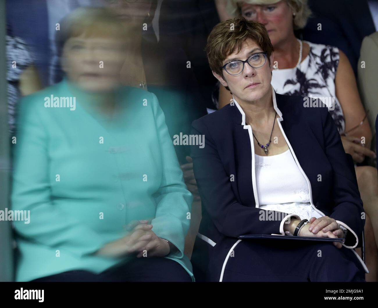 In this picture taken trough a window German Chancellor Angela Merkel, left, and German Defence Minister Annegret Kramp-Karrenbauer, right, attend a meeting of the German Federal Parliament in Berlin, Germany, Wednesday, July 24, 2019. (AP Photo/Michael Sohn) Banque D'Images