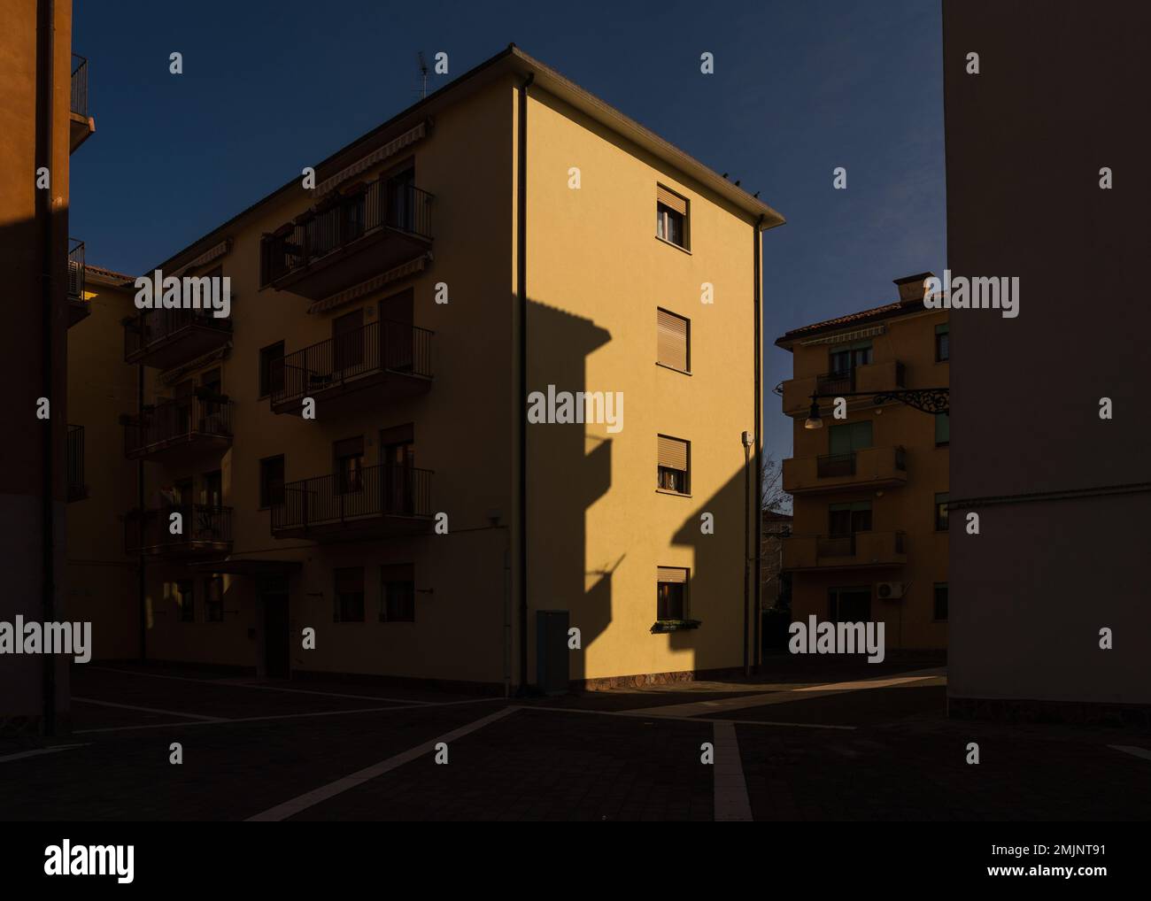 Immeuble d'appartements jaune à Venise, Italie avec contraste élevé d'éclairage Banque D'Images