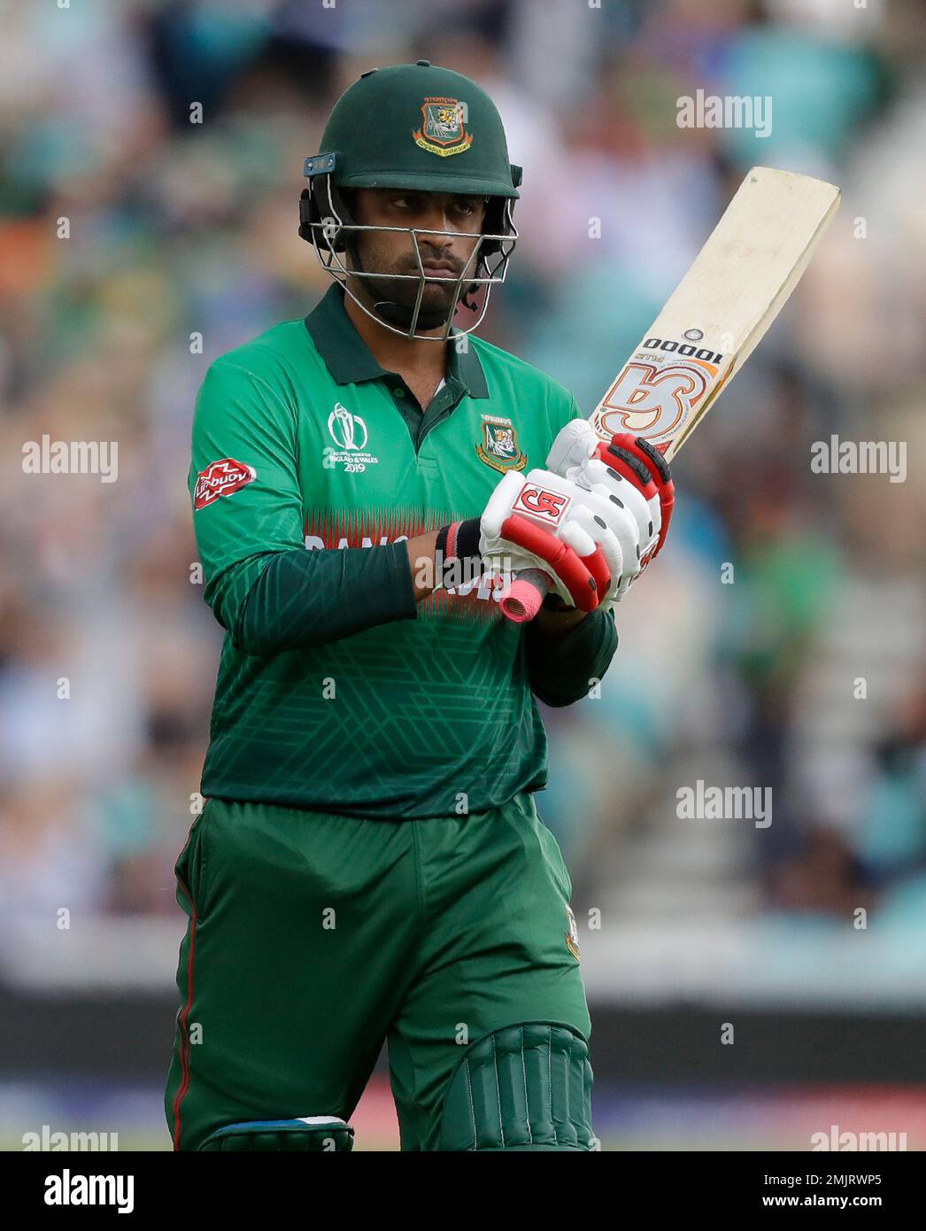 Bangladesh's Tamim Iqbal leaves the pitch after he is caught by New Zealand's Trent Boult off the bowling of New Zealand's Lockie Ferguson during the World Cup cricket match between Bangladesh and New Zealand at The Oval in London, Wednesday, June 5, 2019. (AP Photo/Kirsty Wigglesworth) Banque D'Images