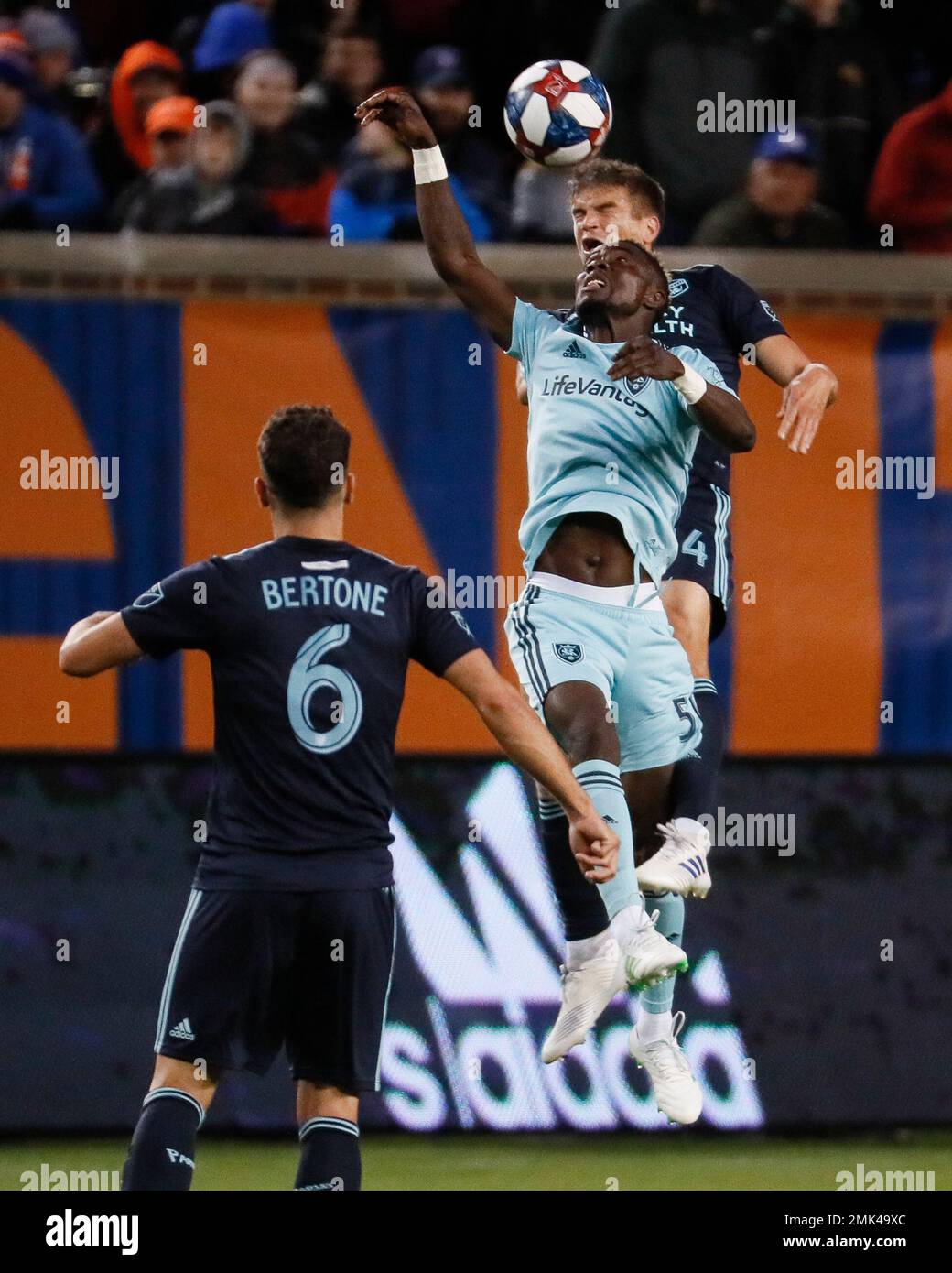 Real Salt Lake forward Sam Johnson, center, and FC Cincinnati midfielder Frankie Amaya, rear, vie for a head ball during the first half of an MLS soccer match Friday, April 19, 2019, in Cincinnati. (AP Photo/John Minchillo) Banque D'Images