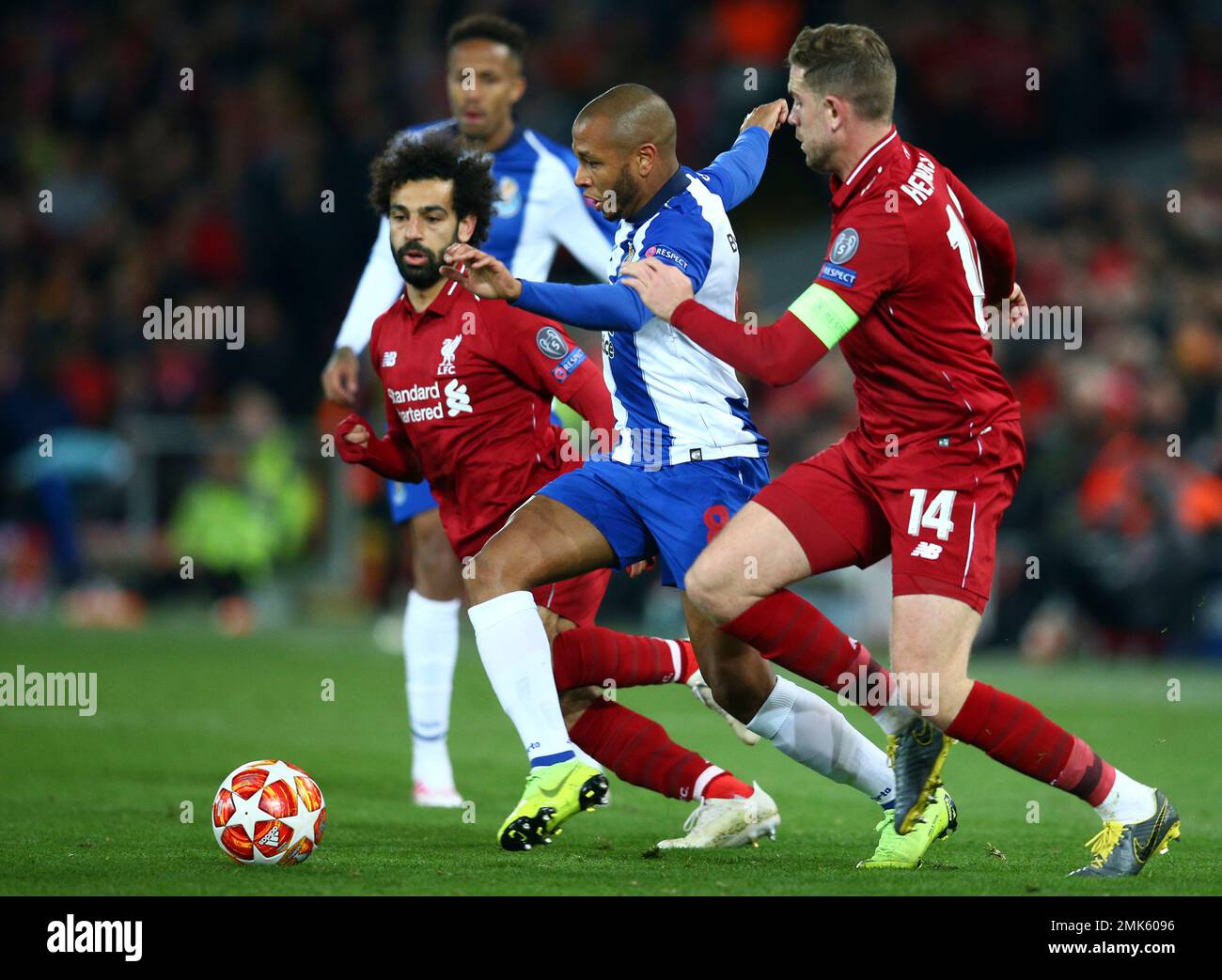 Porto's Yacine Brahimi vies for the ball with Liverpool's Mohamed Salah and Jordan Henderson, right, during the Champions League quarterfinal, first leg, soccer match between Liverpool and FC Porto at Anfield Stadium, Liverpool, England, Tuesday April 9, 2019. (AP Photo/Dave Thompson) Banque D'Images