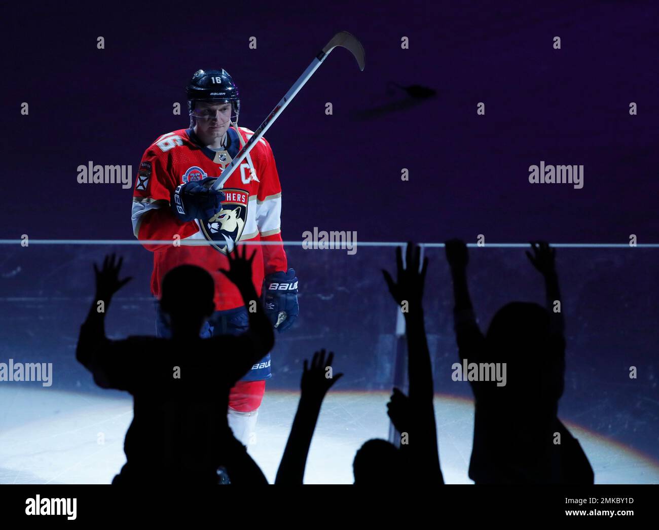 Florida Panthers center Aleksander Barkov gives a fan a hockey stick after being named one of the "Stars of the Game," after the Panthers defeated the Minnesota Wild in an NHL hockey game, March 8, 2019 in Sunrise, Fla. Barkov set a franchise record with five assists. (AP Photo/Wilfredo Lee) Banque D'Images