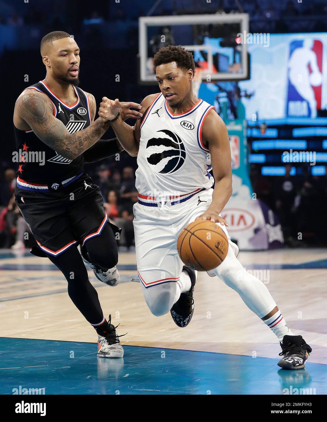 Team Giannis' Kyle Lowry, of the of the Toronto Raptors, moves past Team LeBron's Damian Lillard, of the Portland Trail Blazers during the first half of an NBA All-Star basketball game, Sunday, Feb. 17, 2019, in Charlotte, N.C. (AP Photo/Chuck Burton) Banque D'Images