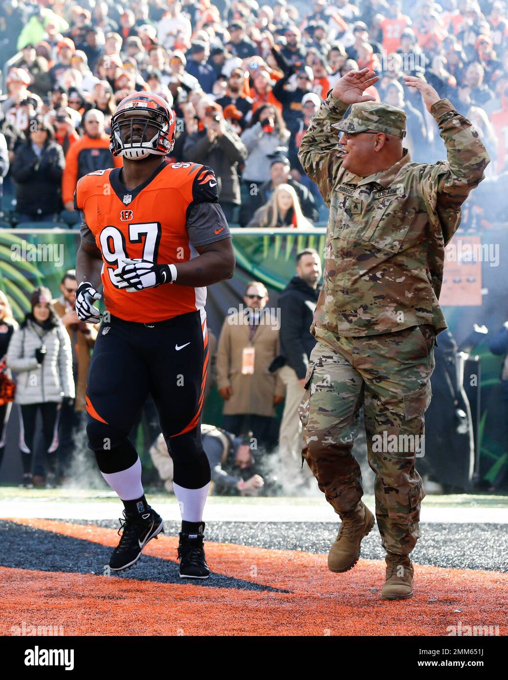 Cincinnati Bengals defensive tackle Geno Atkins (97) takes the field with a member of the armed forces before an NFL football game against the New Orleans Saints, Sunday, Nov. 11, 2018, in Cincinnati. (AP Photo/Frank Victores) Banque D'Images