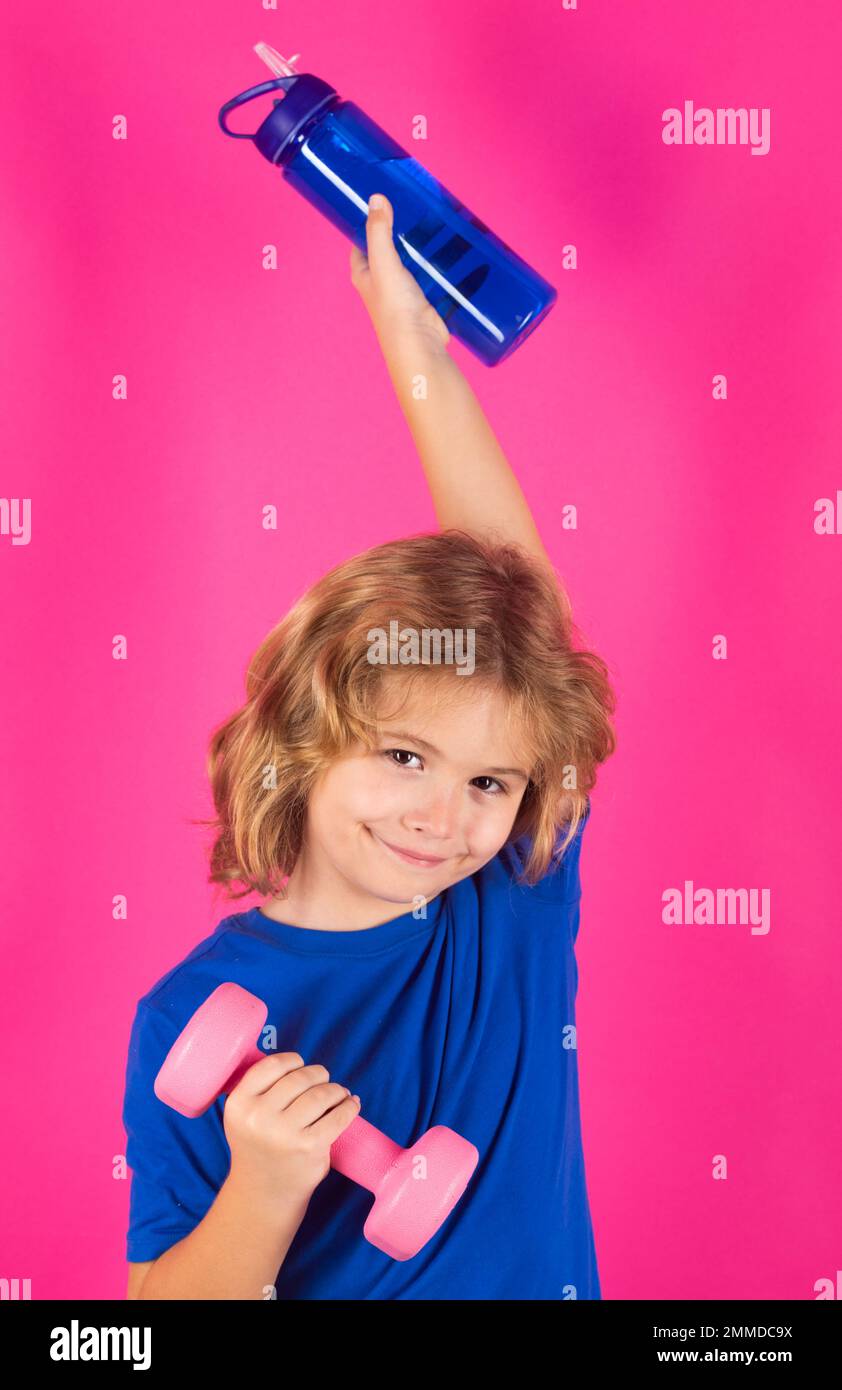 Enfants sportifs, portrait isolé en studio. Activités sportives à loisir avec les enfants. Garçon blond tenant des haltères. Exercices sportifs pour les enfants. Drôle Banque D'Images