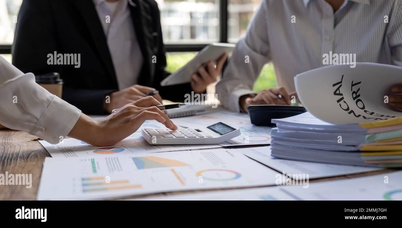 Équipe de gestion financière ou comptable travaillant avec une calculatrice pour calculer le rapport de synthèse des données d'entreprise, le document comptable et l'ordinateur portable à Banque D'Images