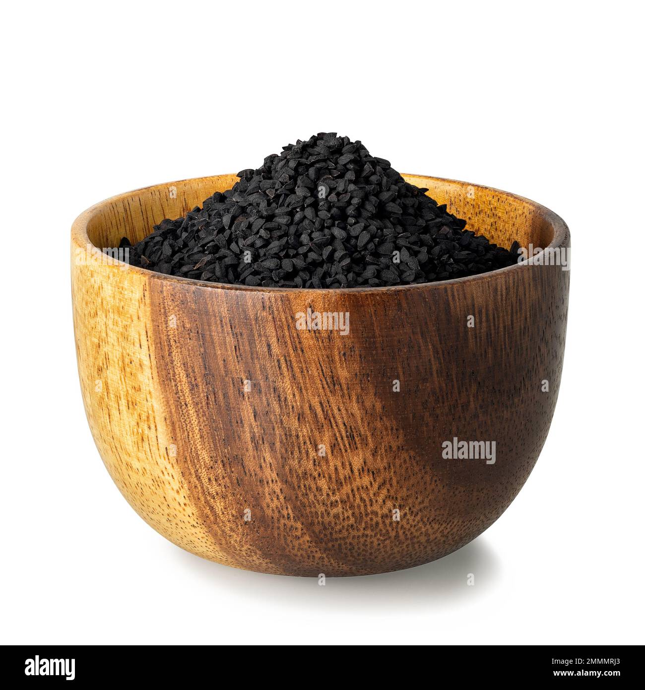 graines de cumin noires dans un bol en bois isolé sur blanc Banque D'Images