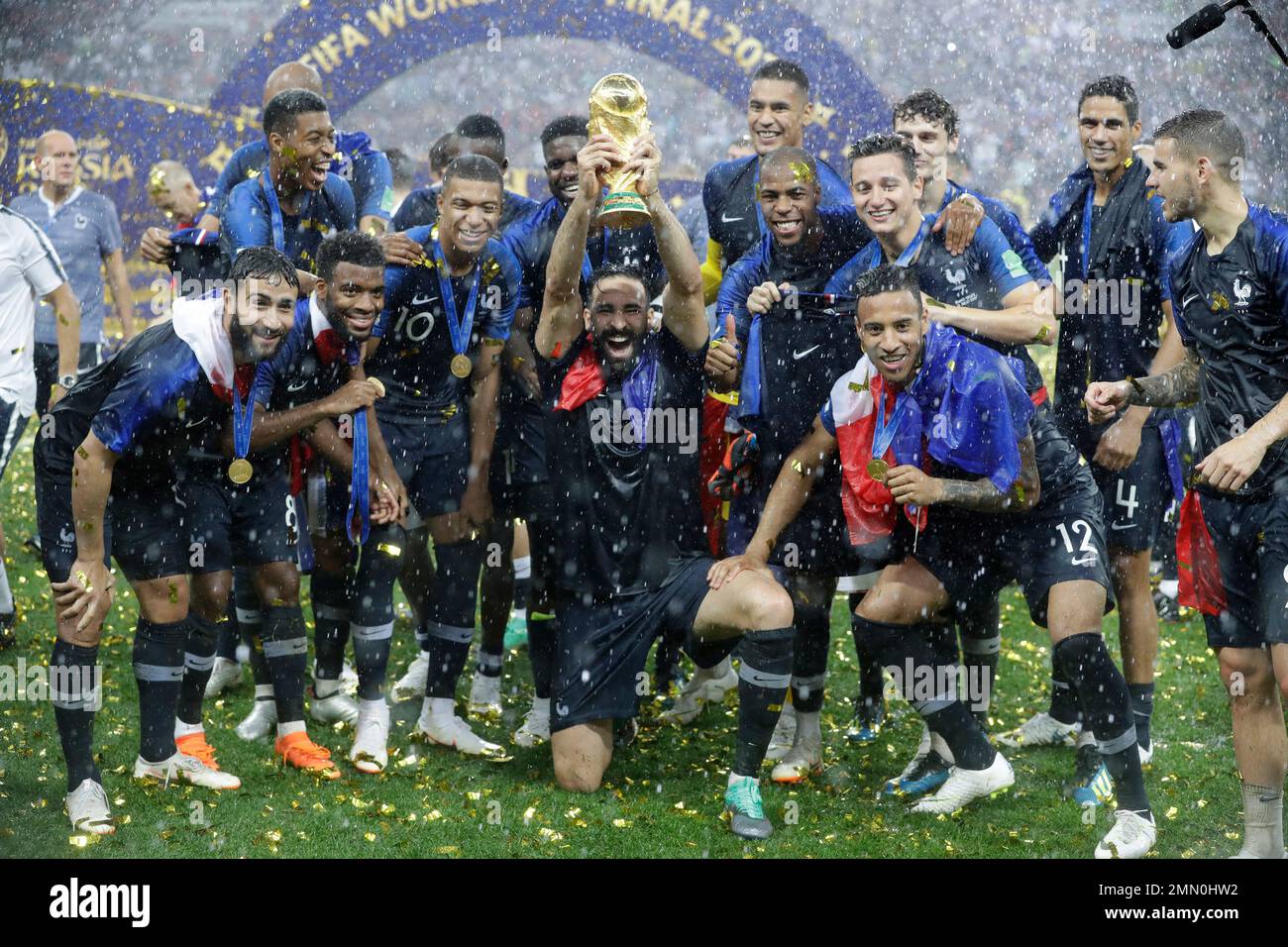 France's Adil Rami, center, celebrates with the trophy after the final match between France and Croatia at the 2018 soccer World Cup in the Luzhniki Stadium in Moscow, Russia, Sunday, July 15, 2018. France won the final 4-2. (AP Photo/Matthias Schrader) Banque D'Images