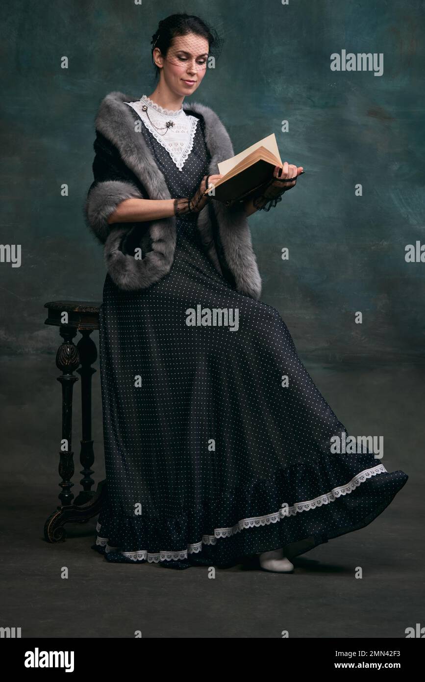 Réservation personnel. Belle femme à l'image d'Anna Karenina lisant sur fond vert foncé vintage. Style vintage. Concept de caractère littéraire Banque D'Images