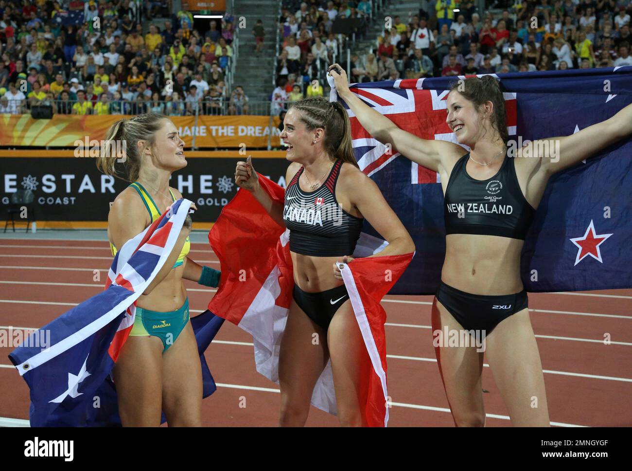 CORRECTS NAME OF WINNER: Gold medal winner Canada's Alysha Newman, center, silver medalist New Zealand's Eliza McCartney, right, and bronze medalist Australia's Nina Kennedy celebrate after the woman's pole vault final at Carrara Stadium during the Commonwealth Games on the Gold Coast, Australia, Friday, April 13, 2018. (AP Photo/Dita Alangkara) Banque D'Images