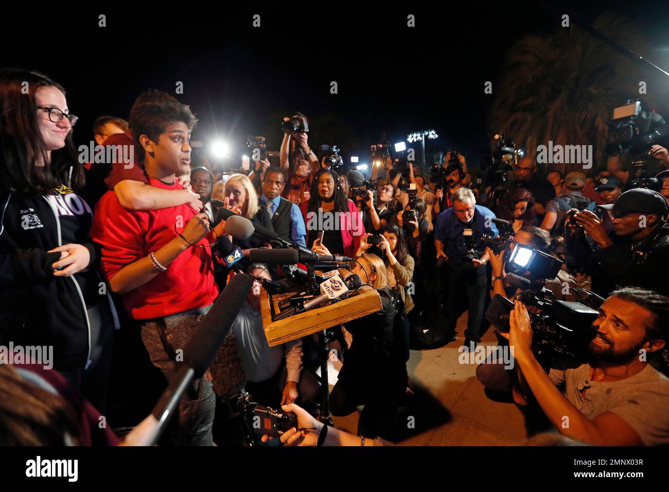 Tanzil Philip, 16, a student survivor from Marjory Stoneman Douglas High School, where 17 students and faculty were killed in a mass shooting on Wednesday, speaks to a crowd of supporters and media as they arrive at Leon High School, in Tallahassee, Fla., Tuesday, Feb. 20, 2018. The students arrived in the state's capital to talk to legislators and rally for gun control reform. (AP Photo/Gerald Herbert) Banque D'Images