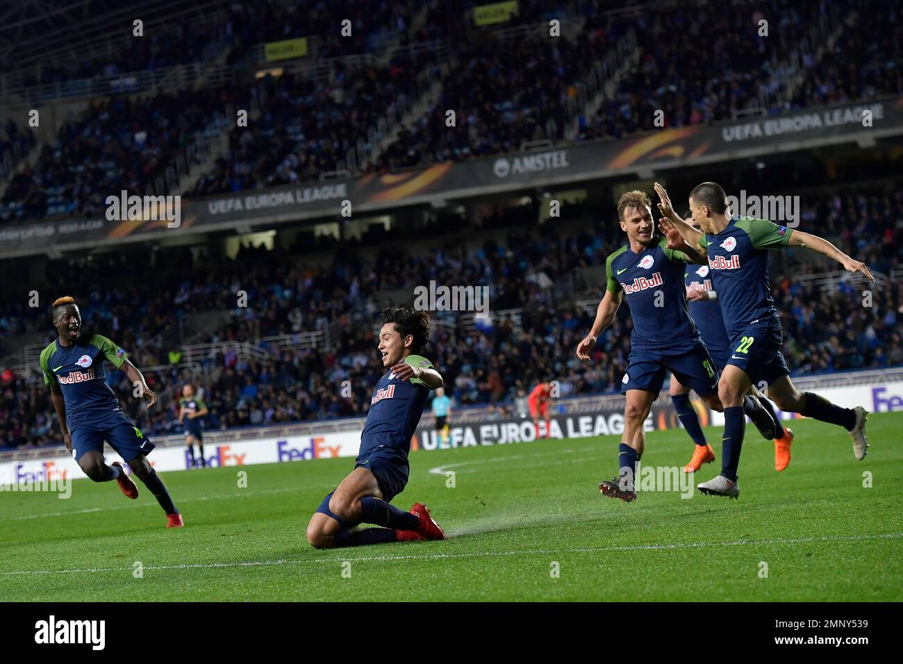 FC Salzburg's Takumi Minamino, center, celebrates with his fellow teammates after scoring his goal and tied the match 2-2 on the last minute against Real Sociedad, during Europa League - round of 32, 1st leg between Real Sociedad and FC Salzburg, at Anoeta stadium, in San Sebastian, northern Spain, Thursday, Feb. 15, 2018. (AP Photo/Alvaro Barrientos) Banque D'Images