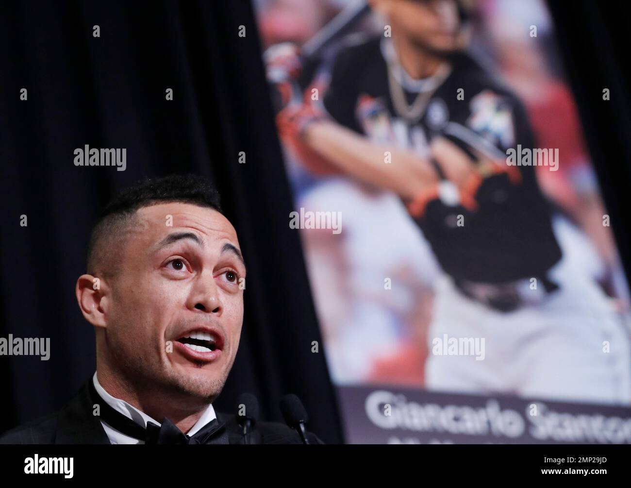 National League Most Valuable Player Giancarlo Stanton speaks beside a
