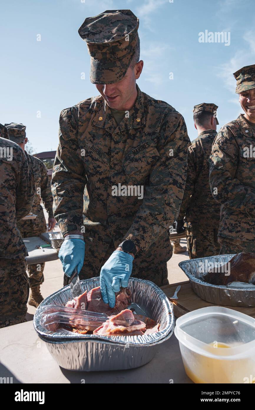 ÉTATS-UNIS Le major Patrick Burns, officier des opérations du 7th Engineer Battalion, 1st Marine Logistics Group, coupe du jambon lors d'un potluck de Thanksgiving pour 7th ESB sur le Camp Pendleton, Californie, le 23 novembre 2022. 7th le coordinateur de préparation au déploiement ESB a organisé un potluck pour les Marines qui vivent dans les casernes afin de construire la camaraderie et la cohésion de l'unité pendant la période des fêtes. Banque D'Images