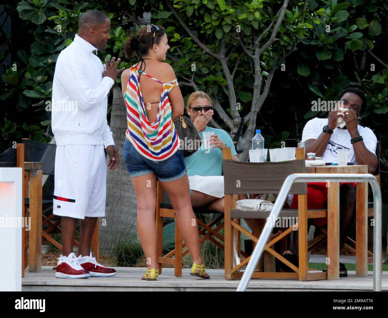 EXCLUSIF !! L'acteur Jamie Foxx a eu ses amis en point de vue lorsqu'il a bavardé avec eux au bord de la piscine dans son hôtel de luxe, avec sa petite amie l'actrice Leila Arcieri, qui portait un haut rayé brillant et un short en denim sur un bikini, à ses côtés. La quartette d'amis, qui semblait juste rencontrer Arcieri, tous ont applaudi et ont fait boire un verre rapide avant de continuer. Avant de se rendre sur leur chemin, Foxx, qui semblait confortable dans un ensemble blanc de vestes, shorts et baskets, a joué au frais et s'est arrêté pour prendre des photos avec plusieurs fans, dont deux étaient de jolies jeunes femmes qu'il a semblé à l'humour comme il a cha Banque D'Images