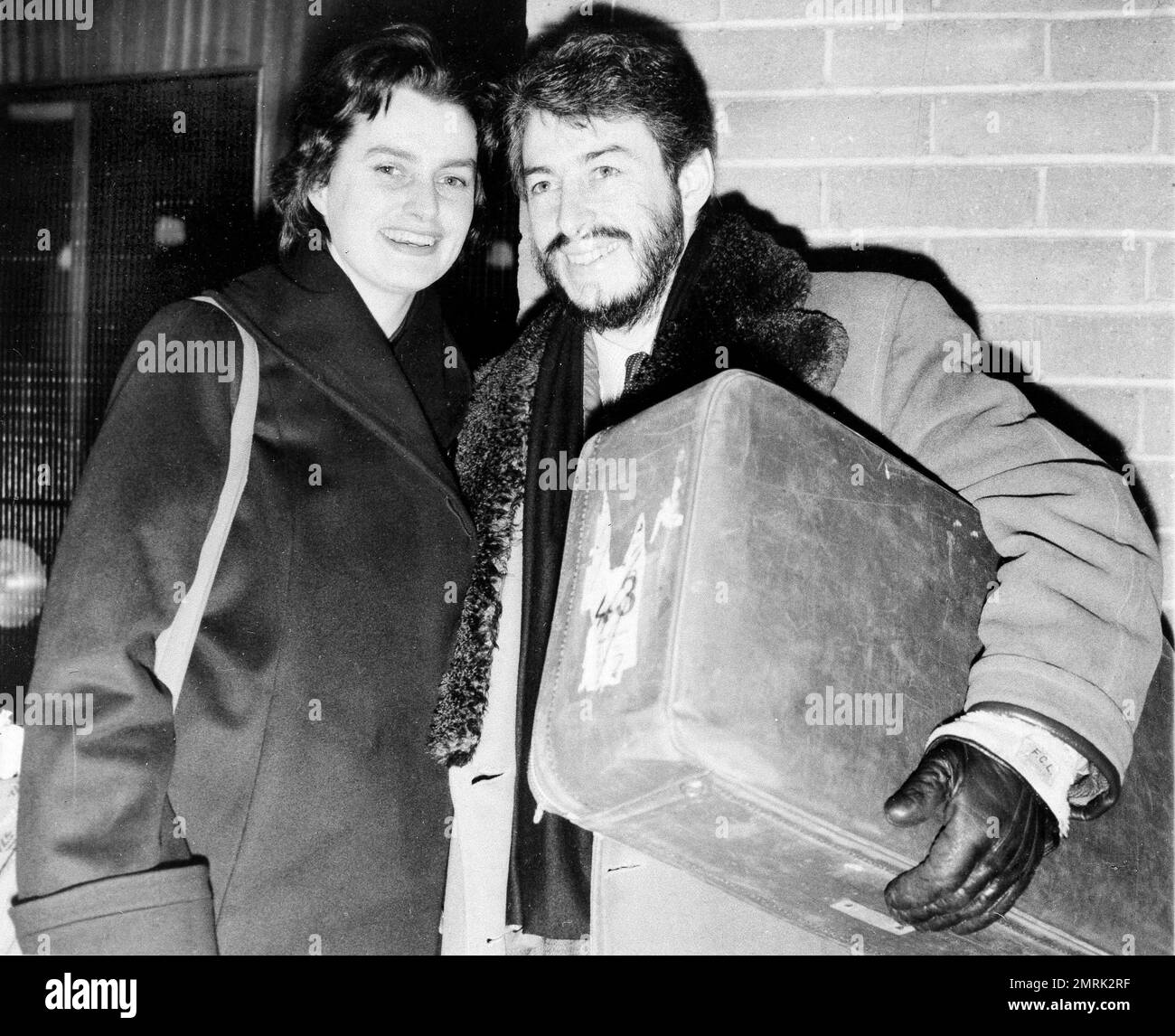 J.P. Donleavy, Irish-American novelist and playwright, whose sardonic "Fairytale of New York" transfers from the New Theater, Croydon, to the Comedy Theater, London, meets his wife Valerie at London Air Terminal, Jan. 23, 1961, on her arrival from Northern Ireland. She interrupted her holiday to rejoin her husband for the West End premiere. (AP Photo) Banque D'Images