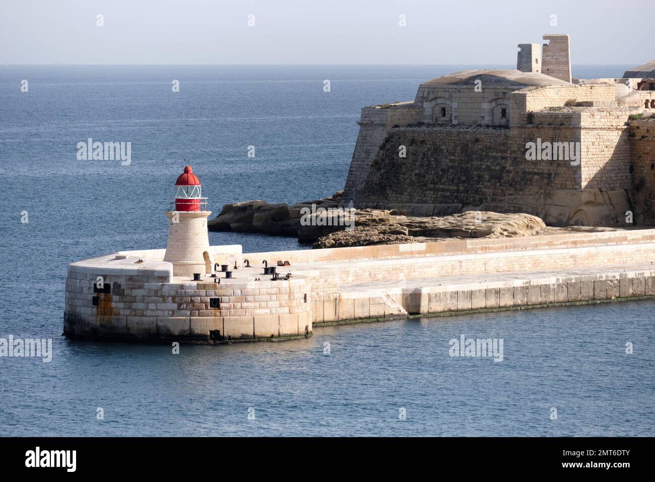 Vue sur le phare rouge et le fort Ricasoli East Breakwater - Malte Banque D'Images