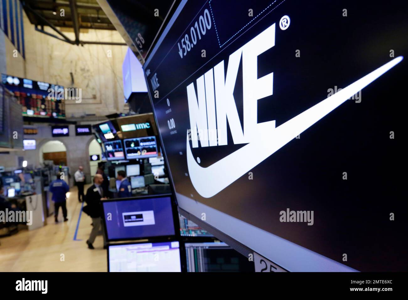 FILE - In this Wednesday, March 22, 2017, file photo, the Nike logo appears  above the post where it trades on the floor of the New York Stock Exchange.  On Thursday, June