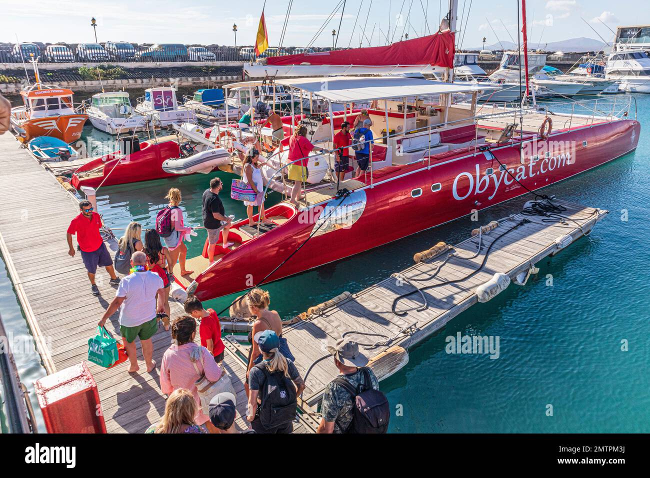 Les touristes embarquant sur le catamaran Obycat Experience dans le port de Caleta de Fuste sur la côte est de l'île des Canaries de Fuerteventura, Espagne Banque D'Images