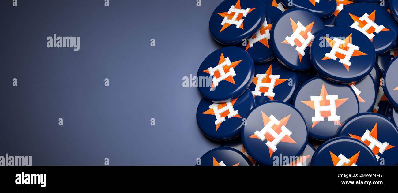 Logos de l'équipe de baseball de la Ligue majeure américaine Houston Astros sur un tas sur une table. Banque D'Images