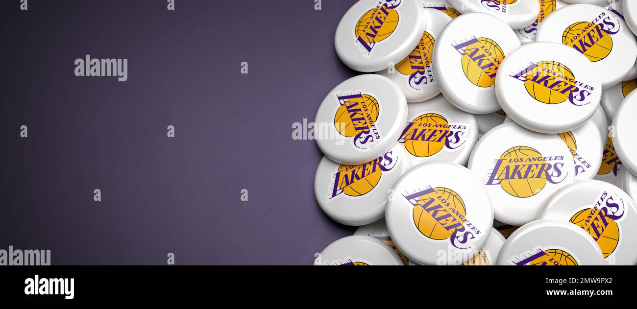 Logos de l'équipe américaine de basket-ball NBA Los Angeles Lakers sur un tas sur une table. Banque D'Images