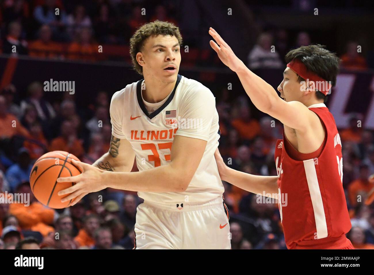 Illinois' Coleman Hawkins (33) looks to pass as Nebraska's Keisei Tominaga, right, defends