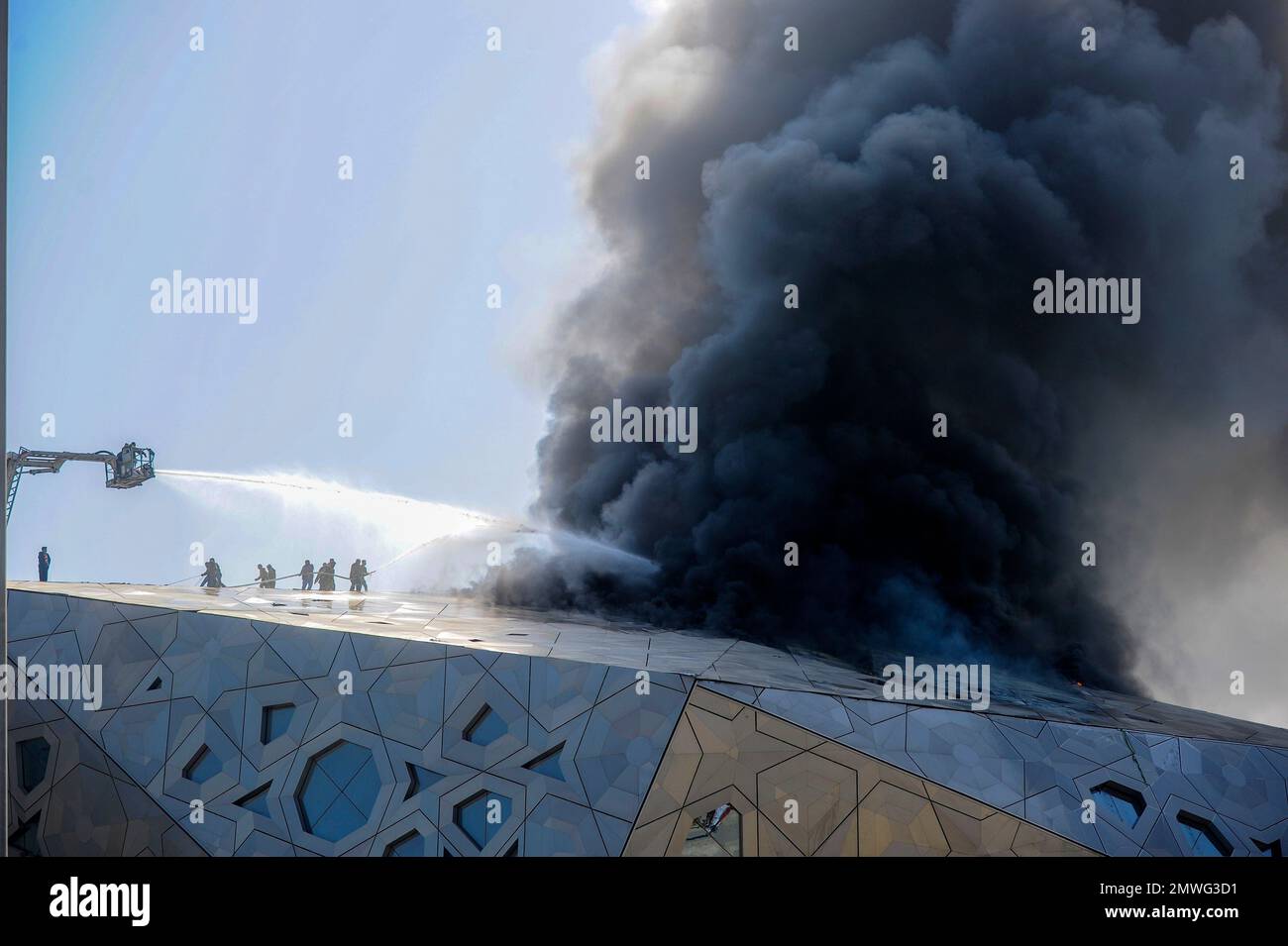 Firefighters work at the site of a fire at the Sheikh Jaber Al Ahmad Cultural Center in Kuwait City, Kuwait, the oil-rich country's recently opened performing arts center on Monday, Feb. 6, 2017. The official Kuwait News Agency said no one was hurt in Monday's fire at the center that opened in early November at a reported cost of more than $700 million. It was expected to begin a performance run of the Andrew Lloyd Webber musical "Cats" this week. (AP Photo) Banque D'Images