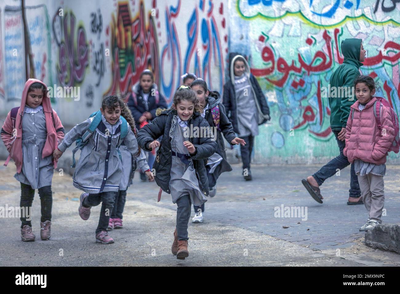 Les étudiants palestiniens qui sortent de l'école rentrent chez eux par mauvais temps dans la ville de Gaza. Banque D'Images