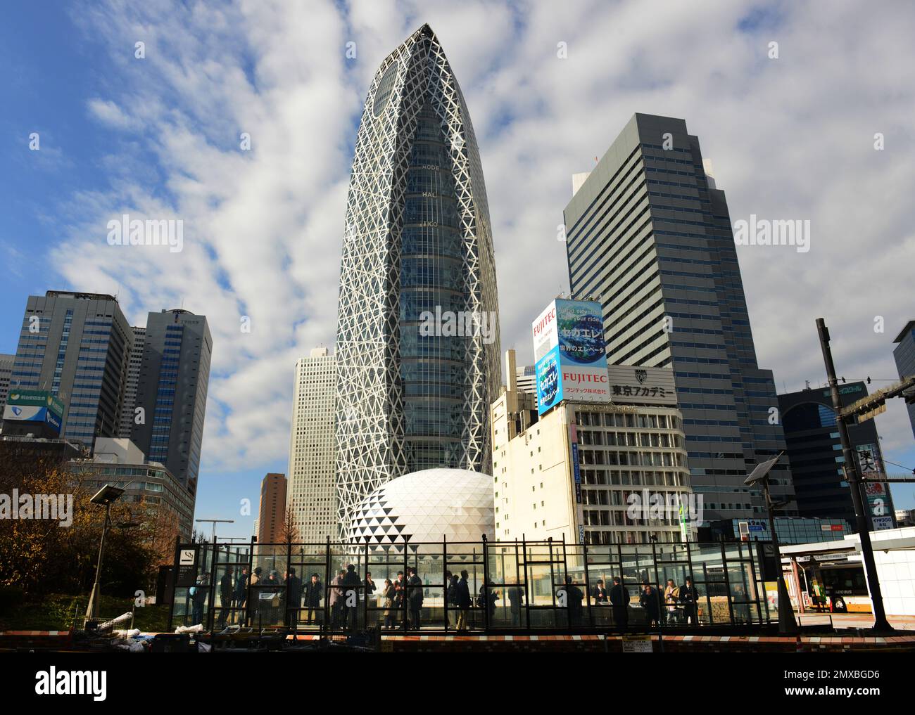 Des hommes japonais fument dans une zone de fumage en cage de verre à Shinjuku, Tokyo, Japon. Banque D'Images