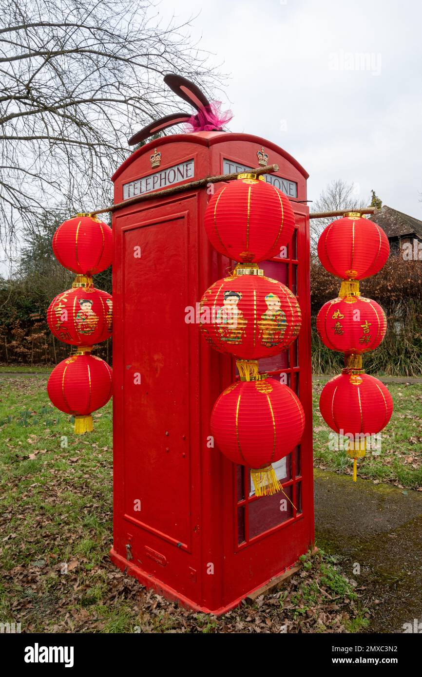 Ancienne boîte téléphonique rouge (borne téléphonique) décorée pour le nouvel an chinois, année du lapin, dans le village de Surrey de Compton, au Royaume-Uni. Janvier 2023 Banque D'Images