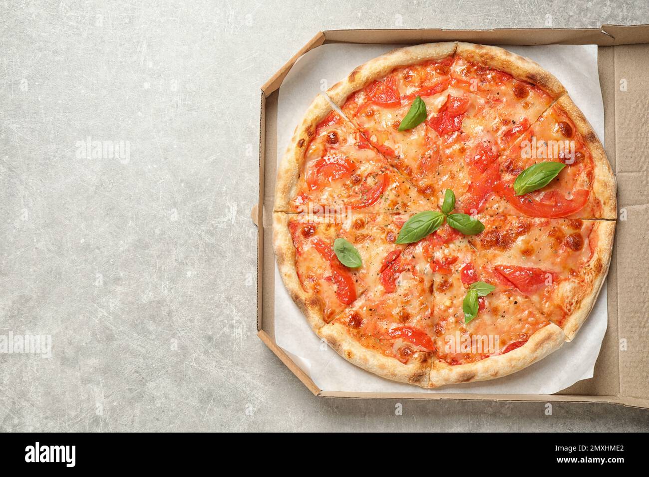 Délicieuse pizza Margherita sur une table gris clair, vue du dessus. Espace pour le texte Banque D'Images