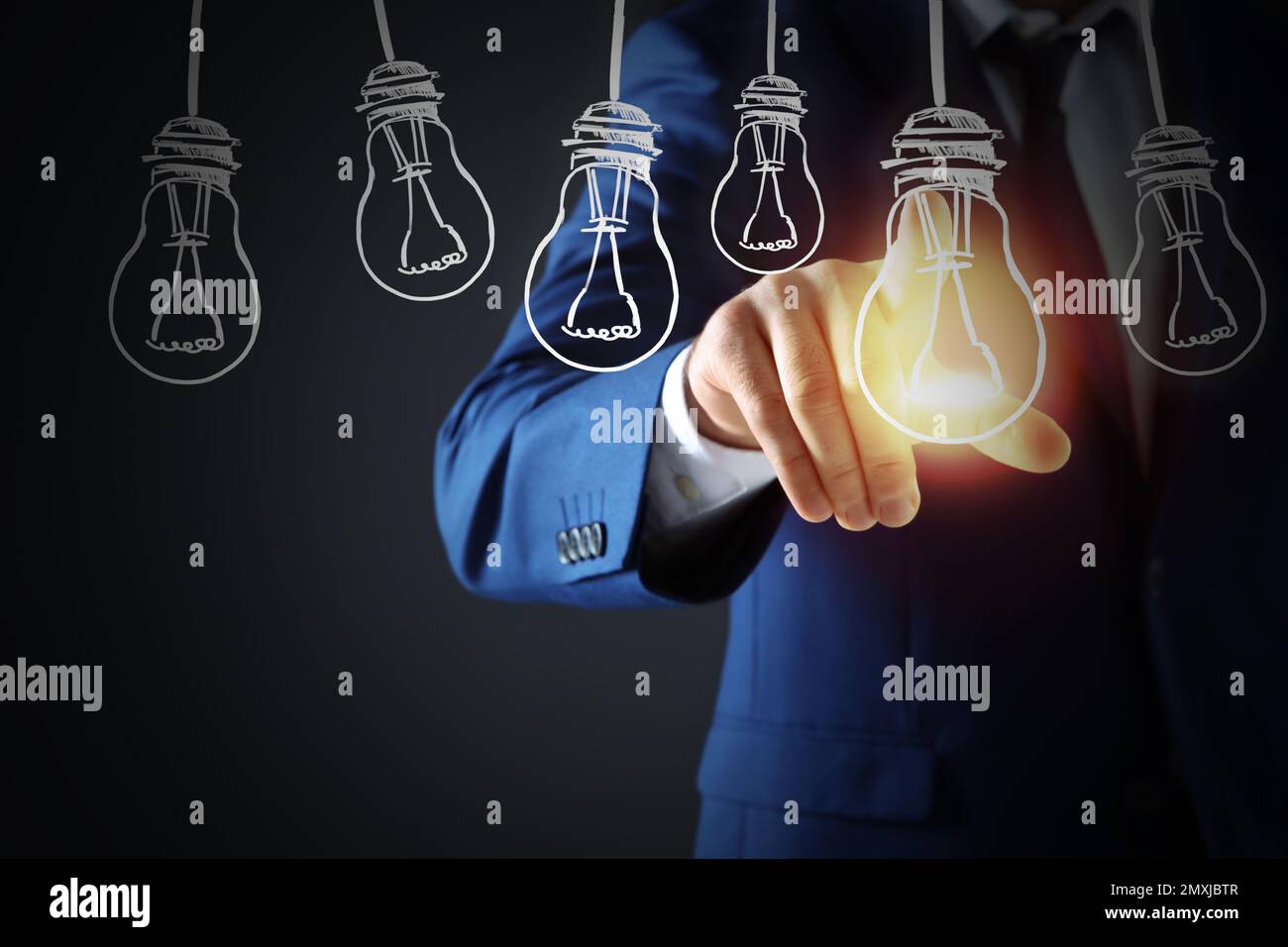 Concept d'idée. Homme d'affaires touchant l'ampoule lumineuse sur l'écran virtuel, gros plan Banque D'Images