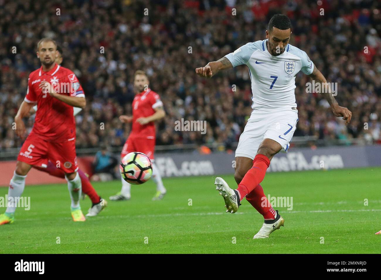 England’s Theo Walcott, right, shoots during the World Cup Group F qualifying soccer match between England and Malta at Wembley stadium in London, Saturday Oct. 8, 2016. (AP Photo/Tim Ireland) Banque D'Images