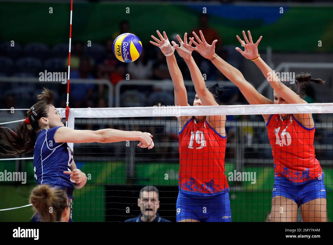 Italy's Antonella del Core, left, spikes the ball past Serbia's Tijana  Boskovic (19) and Milena Rasic (16) during a women's preliminary volleyball  match at the 2016 Summer Olympics in Rio de Janeiro,