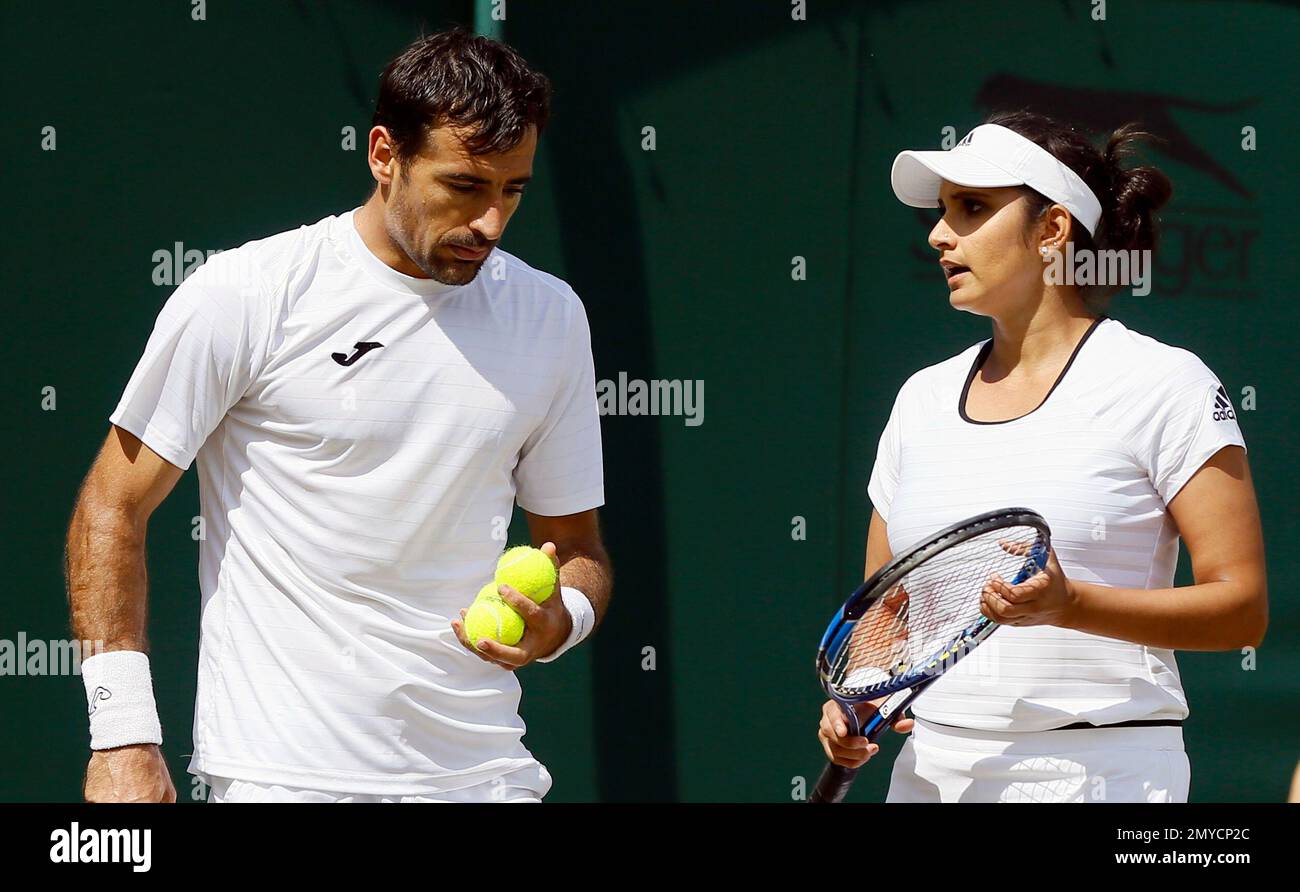 Sania Mirza of India speaks to partner Ivan Dodig of Croatia during their  mixed doubles match against Neal Skupski and Anna Smith of Britain on day  nine of the Wimbledon Tennis Championships