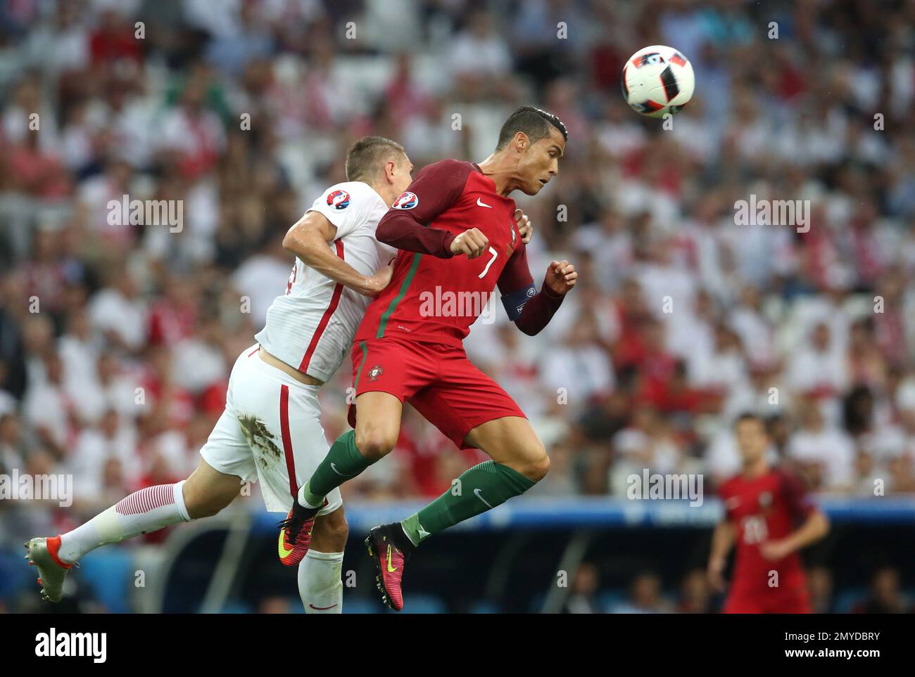 Portugal's Cristiano Ronaldo, right, heads a ball next to Poland's Artur Jedrzejczyk during the Euro 2016 quarterfinal soccer match between Poland and Portugal, at the Velodrome stadium in Marseille, France, Thursday, June 30, 2016. (AP Photo/Petr David Josek) Banque D'Images