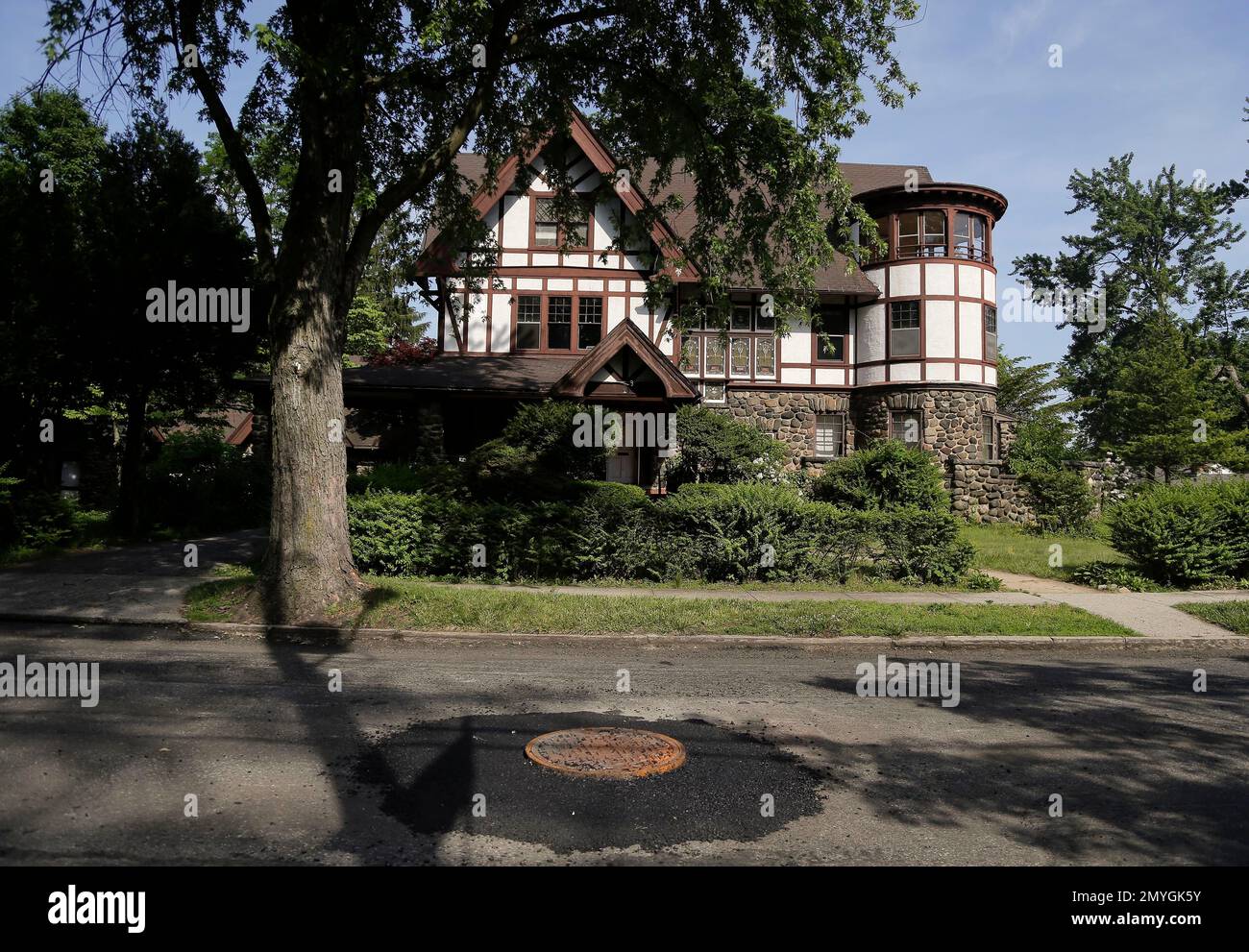 Overgrown grass and thick bushes cover the landscape around a medieval